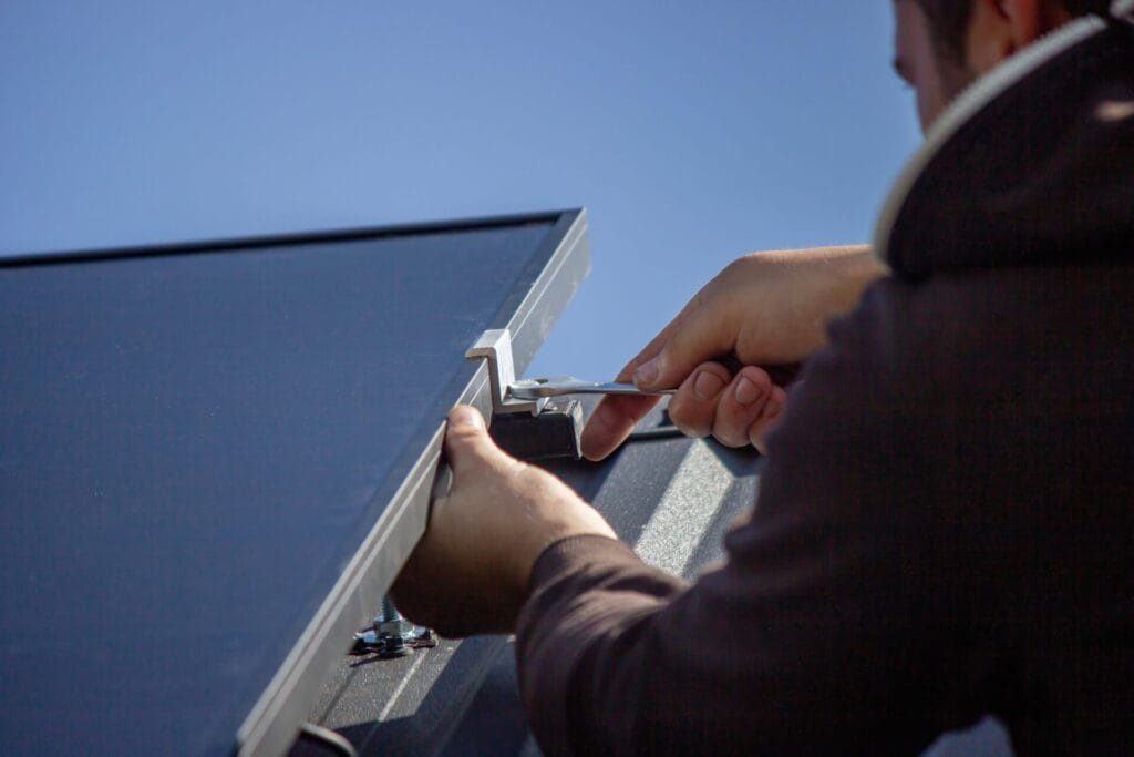 a-man-is-installing-solar-panels-on-a-roof-select-2025