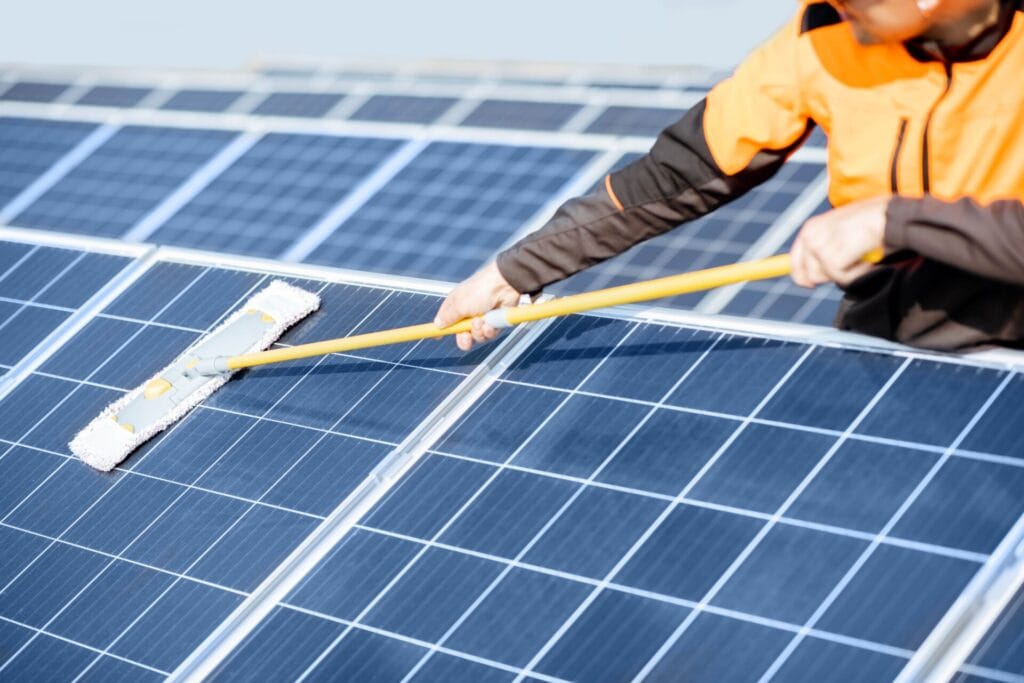 workman-cleaning-solar-panels